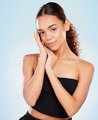 Buy stock photo Shot of a young woman posing against a blue background