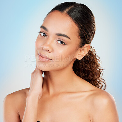 Buy stock photo Shot of a young woman posing against a blue background