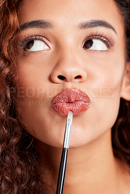 Buy stock photo Closeup shot of a young woman applying lipstick