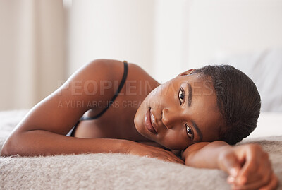 Buy stock photo Shot of a beautiful young woman lying on her bed