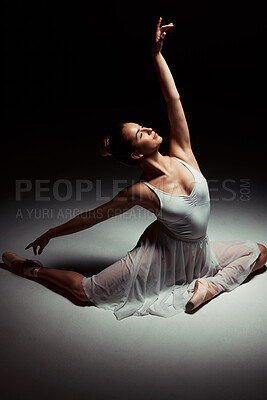 Buy stock photo Full length shot of an attractive young ballerina dancing alone in the studio