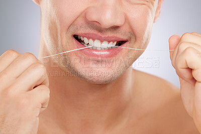 Buy stock photo Closeup shot of a man flossing his teeth