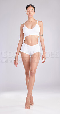 Buy stock photo Full length shot of an attractive young woman standing and posing in her underwear in the studio