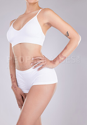 Buy stock photo Cropped shot of an unrecognisable woman standing and posing in her underwear in the studio