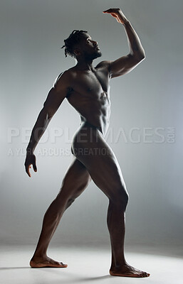 Buy stock photo Shot of a muscular young man posing nude in studio against a grey background