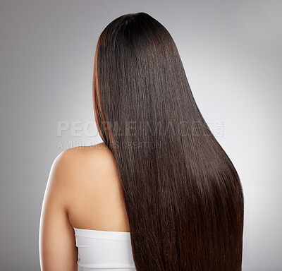 Buy stock photo Rearview shot of a young woman with long silky hair against a grey background