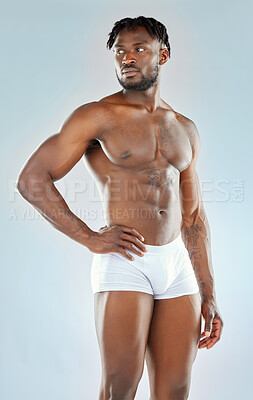 Buy stock photo Studio shot of a muscular young man posing shirtless