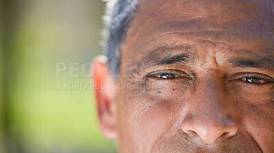Buy stock photo Cropped shot of an unrecognisable man looking into the camera during a day in the park