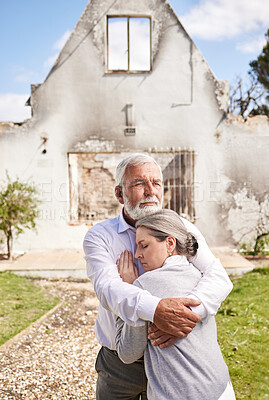 Buy stock photo Shot of a senior couple comforting each other after losing their home to a fire