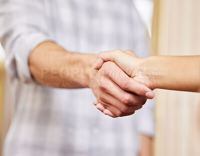 Buy stock photo Cropped shot of two unrecognizable businesspeople shaking hands while standing in an office