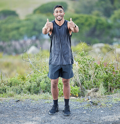 Buy stock photo Full length shot of a handsome young man standing alone and showing a thumbs up after his outdoor run