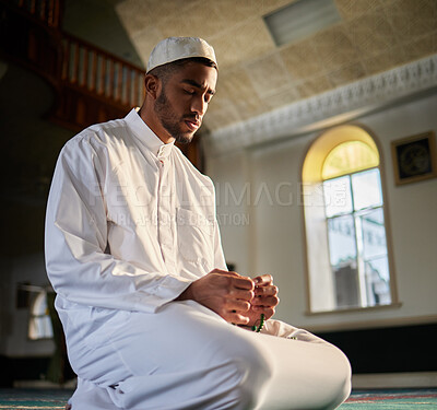 Buy stock photo Shot of a young muslim male praying in a mosque
