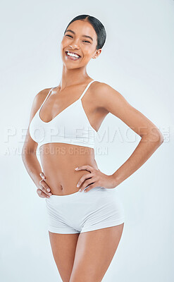 Buy stock photo Shot of an attractive young woman standing alone in the studio and posing in her underwear