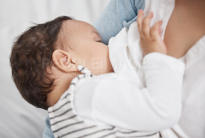 Buy stock photo Shot of a baby breast feeding at home