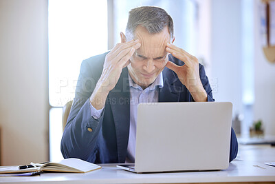 Buy stock photo Shot of a mature businessman suffering from a headache in an office at work
