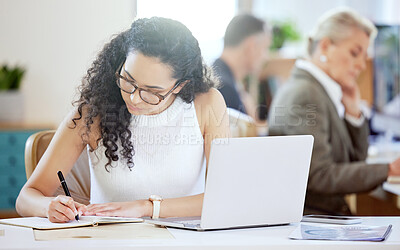 Buy stock photo Shot of a young businesswoman writing in a diary in an office at work