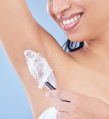 Buy stock photo Shot of a young woman using a disposable razor to shave her underarms
