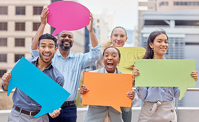Buy stock photo Shot of a group of young businesspeople holding speech bubbles against a city background