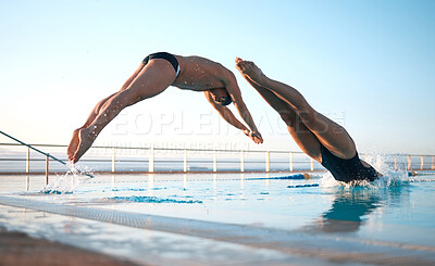 Buy stock photo Shot of two young athletes diving into an olypmic-sized swimming pool