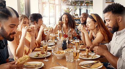 Buy stock photo Shot of a group of young friends enjoying a meal together at a restaurant