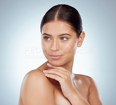 Buy stock photo Beautiful woman with smooth glowing skin and copyspace posing topless and touching shoulder and chin. Serious caucasian model isolated against a grey studio background with healthy skincare routine