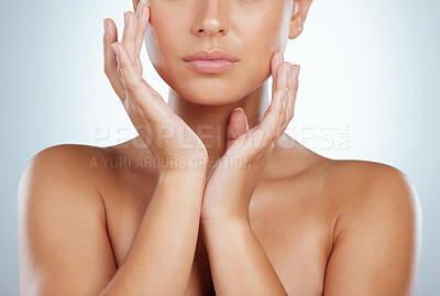 Buy stock photo Closeup of unknown woman perfect lips touching her face in studio. Caucasian model with smooth glowing skin isolated against a grey background and showing manicured hand. Healthy self care routine