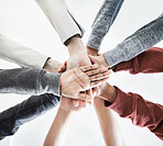 Low view of Group of businesspeople stacking their hands in support with their colleagues standing in a meeting in an office at work. Businesspeople piling their hands for motivation and success together