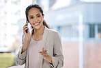 Business woman talking on her phone. Female entrepreneur making a call on her smartphone. Portrait of smiling businesswoman on a phone call. Businesswoman in her office making a call on her mobile