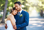 Beautiful bride leaning on grooms shoulder while standing outside. Loving newlywed couple enjoying romantic moments together. Feeling safe and secure