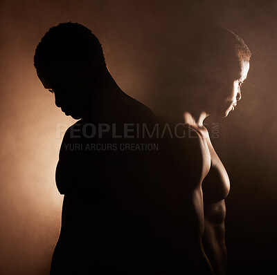 Buy stock photo Two handsome, muscular young african american men in studio against a dark background. Macho male athletes looking thoughtful isolated on black. Exercising body and mind. A question of mental health