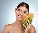 Portrait of beautiful woman holding protea flowers with copyspace. Caucasian model isolated against grey background in a studio with smooth glowing skin and posing topless. Healthy skincare routine