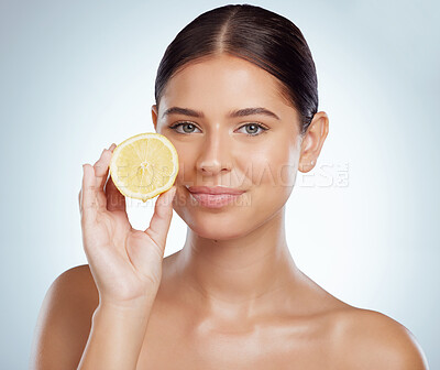 Buy stock photo Portrait of beautiful woman holding ripe lemon while posing topless with copyspace. Caucasian model isolated against grey background in studio with smooth glowing skin, fresh healthy skincare routine