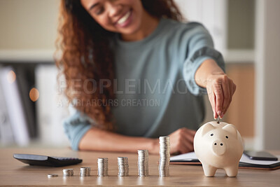 Buy stock photo Young african american woman money putting coins into a piggybank at home. Mixed race person counting coins while financial planning in her living room. Saving, investing and thinking about the future