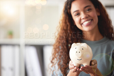 Buy stock photo Beautiful young african american woman presenting her piggyback while standing in the living room it at home. Happy mixed race person smiling while planning, saving and investing for a bright future