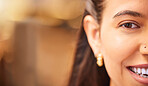 Closeup Portrait of a young mixed race woman smiling and looking happy with a nose piercing. Cropped closeup of a hispanic females face in the foreground against a blurred background. Smile a while and give your face a rest