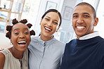 Portrait of a group of three cheerful diverse businesspeople taking a selfie together at work. Happy mixed race businessman taking a photo with his joyful female colleagues