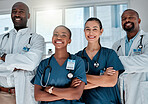 Group of happy doctors standing with their arms crossed while working at a hospital. Expert medical professionals smiling and standing at work together at a clinic
