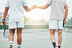 Two unknown ethnic tennis players giving fistbump with fist before playing court game. Fit athletes team standing and using hand gesture for good luck. Play competitive sports match for health fitness