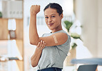Young happy mixed race woman showing and holding her arm with a bandaid after getting a vaccine. Beautiful and confident young woman playing a showing her muscles after getting a covid vaccine
