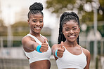 Portrait of african american tennis players with a thumbs up. Happy friends support each other before tennis practice. Young tennis players celebrate their success after a match