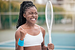 Excited woman cheering after a tennis match. Young tennis player enjoying a game of tennis on the club court. African american player competing in a tennis match. Sporty tennis player on the court
