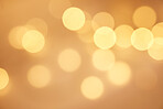 Abstract blurry twinkled lights background with bokeh defocused yellow lights. Closeup blurred glittery sparklng lights. Closeup blurry candle lights at an evening celebration