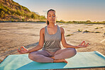 Full length yoga woman meditating with legs crossed for outdoor practice in remote nature. Mixed race mindful active person sitting alone and balancing for mental health. Young hispanic serene and zen
