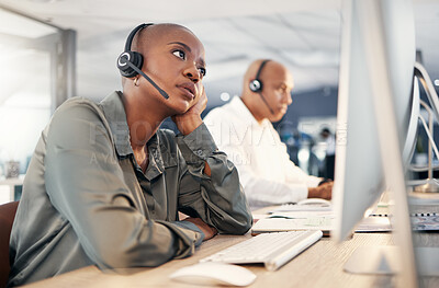 Buy stock photo Stressed african american call centre telemarketing agent looking bored and anxious while working on broken computer in an office. Worried female consultant having problems with slow internet connection error. Lazy employee struggling with difficult callers
