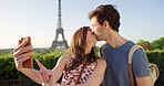 Young couple in love kissing and taking selfies on holiday in Paris