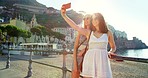 Two happy friends taking selfies.Two women taking selfies on the coast using a cellphone