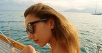 Carefree sexy young woman enjoying herself shaking her head and hair out during a cruise. Sexy young woman in sunglasses enjoying a yacht cruise. woman wearing sunglasses during a cruise