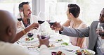 Closeup of multi racial diverse friends having a lunch party at a restaurant and doing a cheers while enjoying a glass of red wine. A group of friends having some salad and celebrating an occasion with an alcoholic beverage